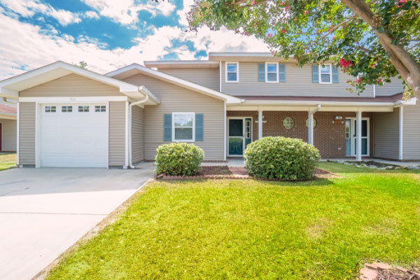 Two Story Home Exterior With Front Yard And Garage