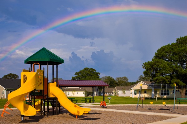 Community Playground With Rainbow In The Sky