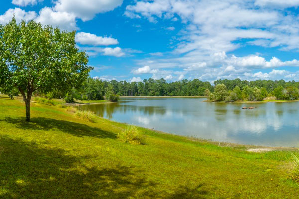 Grassy Hill Leading To Large Lake